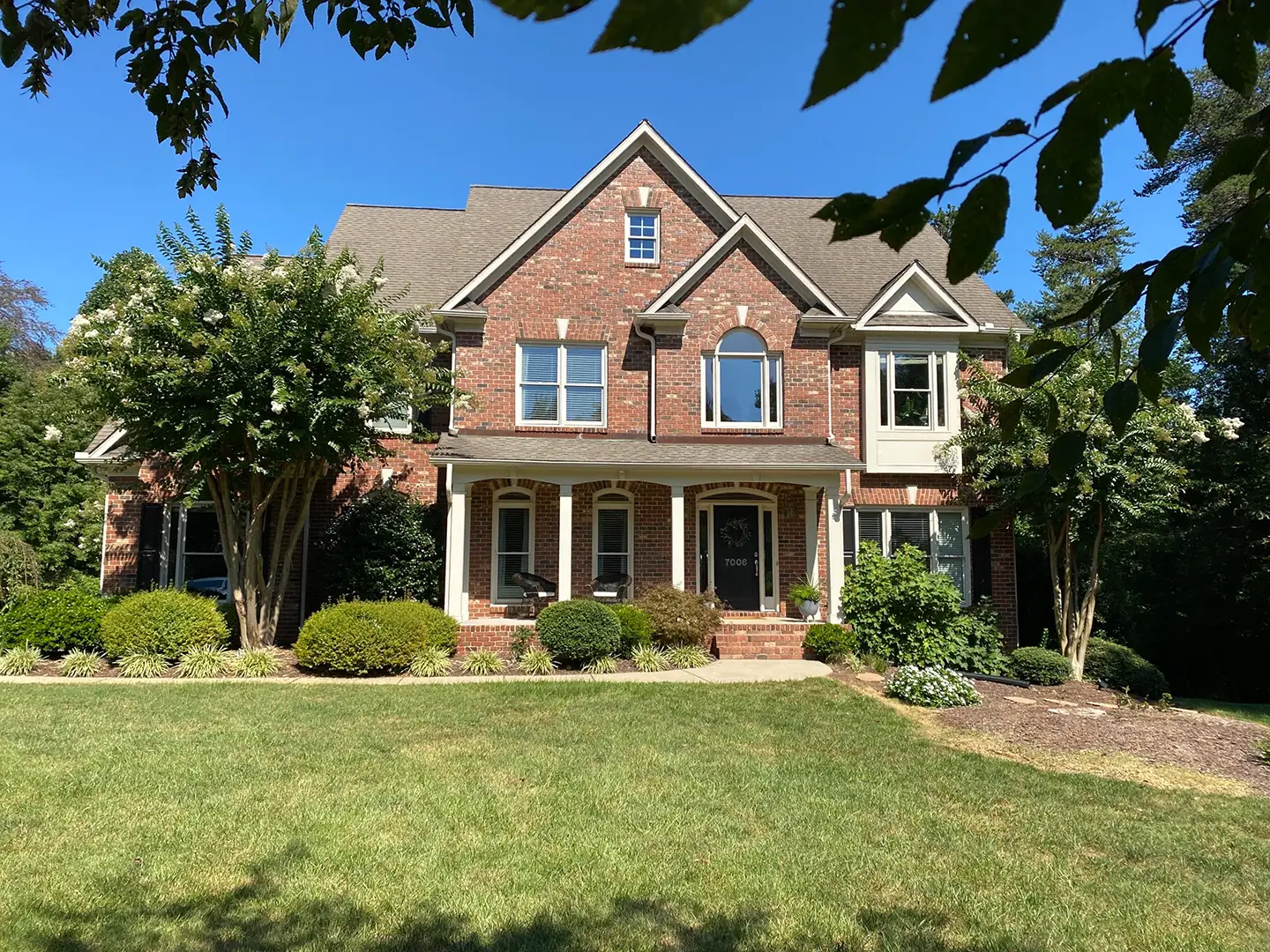 Architectural asphalt shingle roof replacement on a brick home by Redeem Roofing